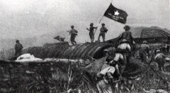 Các chiến sỹ giơ cao lá cờ chiến thắng trong ngày quân địch đầu hàng.